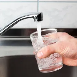 Glass filling with water from faucet